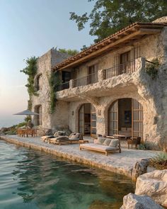 a large house sitting next to a body of water