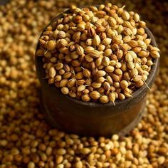 a wooden bowl filled with seeds on top of a table