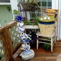 a potted plant sitting on top of a wooden bench next to a chair and table