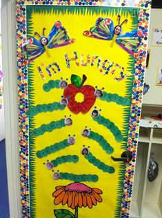 a very colorful door decorated with flowers and butterflies