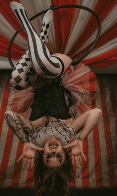 a woman is upside down on the ground with her legs spread out in front of her