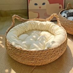 two wicker baskets sitting on top of a floor next to each other, one with a mattress in the middle