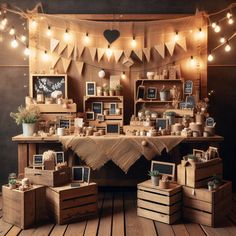 a room with wooden crates and pictures on the wall, lights strung from above it