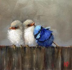 two little birds sitting on top of a wooden fence