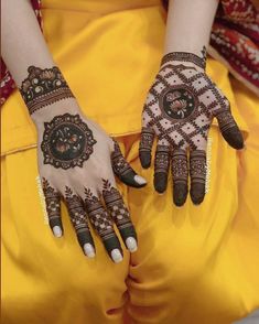 a woman's hands with henna tattoos on them