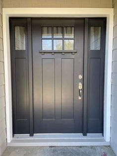 a gray front door with two windows