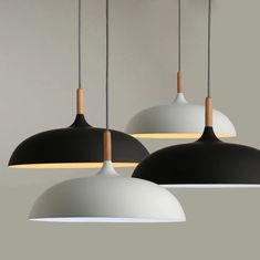 three black and white lights hanging from the ceiling