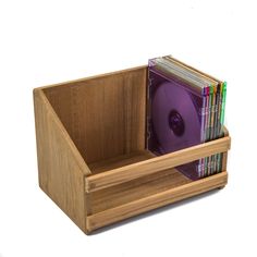 a wooden box with cd's in it