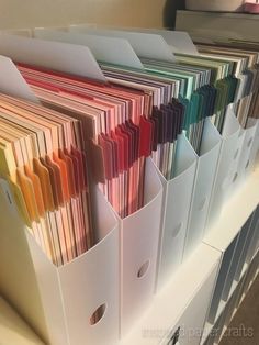 several folders are stacked on top of each other in different colors and sizes,