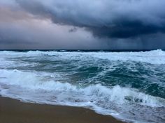 storm clouds over the ocean with waves coming in