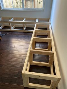 a room with wood flooring and built in benches