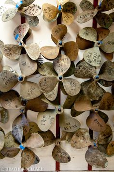 a group of hearts with writing on them hanging from the side of a white wall