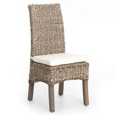 a wicker dining chair with white cushion