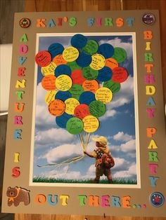 a child holding a bunch of balloons with words written on it