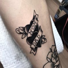 a black and white tattoo on the leg of a woman's arm that says mom day