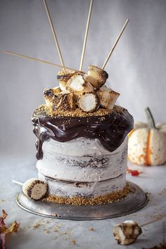 a cake with marshmallows and other toppings sitting on top of it