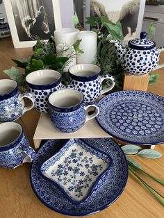 blue and white dishes are arranged on a table