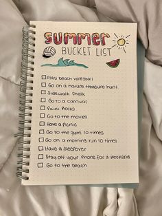 a summer bucket list on top of a bed