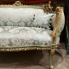 an ornate couch with two pillows on it