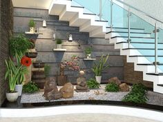 a set of stairs leading up to the top floor with potted plants and rocks