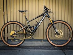 a bike parked in front of a garage door with no wheels on the ground next to it