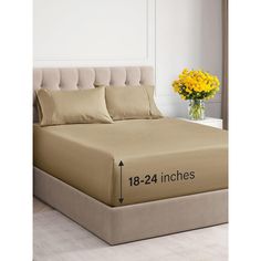 the bed is made and has three pillows on it, with measurements for each pillow