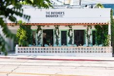 the butcher's daughter is located in an old building with vines growing on it