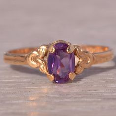 This Stunning Piece, Known As The Regal Amethyst, Features A Captivating Oval-Cut Amethyst At Its Center, Exuding A Rich Purple Hue. The Amethyst Is Elegantly Set In A 14 Karat Gold Band With Intricate Detailing That Enhances Its Regal Appearance. This Exquisite Ring Is Currently A Finger Size 4.5 Yet Can Be Adjusted To Any Finger Size For An Additional Charge Upon Request, Ensuring A Perfect Fit. Lavender Wedding Ring, Vintage Amethyst Ring, Amethyst Ring Vintage, Yellow Gold Color, Purple Rings, Alexandrite Ring, Rich Purple, Unusual Jewelry, Lavender Wedding