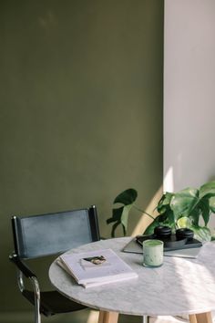 a table with a book and some plants on it