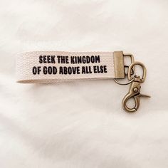 a keychain with the words seek the kingdom of god above all else on it