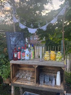 an outdoor bar with bottles and glasses on it