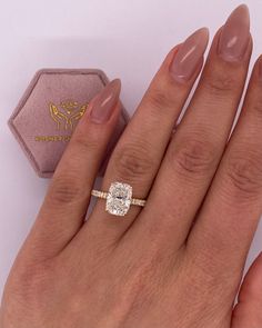 a woman's hand with a ring on it and a diamond in the middle