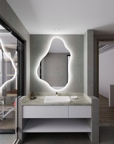 a bathroom with a sink, mirror and lights on the wall