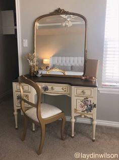 a white desk with a mirror and chair in front of it on top of carpeted floor