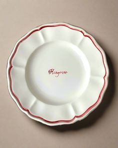 a white and red plate with the words 91th anniversary written in red on it