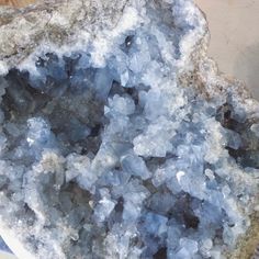 some kind of rock that is covered in blue and white ice flakes on top of it