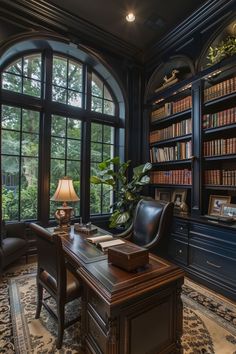 an elegant home office with large windows and bookshelves