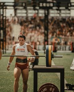 a woman in red shorts lifting a barbell