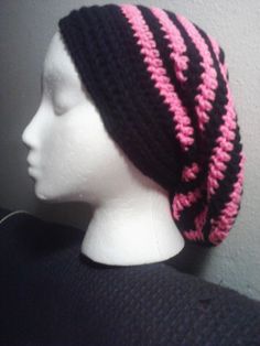 a white mannequin head wearing a black and pink hat