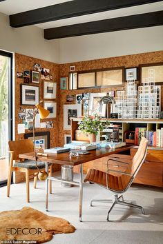 a room with a desk, chair and bookshelf filled with lots of books