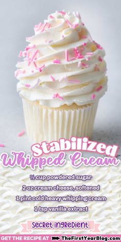 a cupcake with white frosting and pink sprinkles