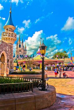 an amusement park with people walking around it