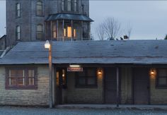 an old wooden building with two doors and windows