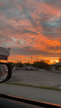 the sun is setting over an empty parking lot