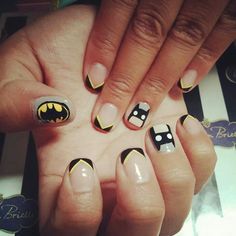 a woman's hand with black and white nail art on it, holding up her nails