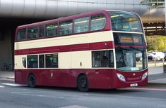 a double decker bus is parked in front of the entrance to an underground parking garage