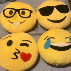 four yellow emoticions with black glasses on their faces and one has a red heart