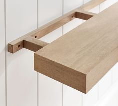 a close up of a wooden shelf on a wall