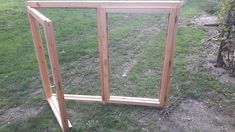 an open window sitting on top of a grass covered field