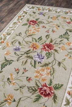 an area rug with flowers and leaves on it